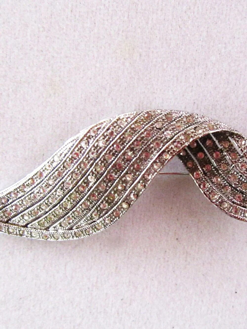 Clear pave rhinestone free form ribbon brooch in silver tone setting